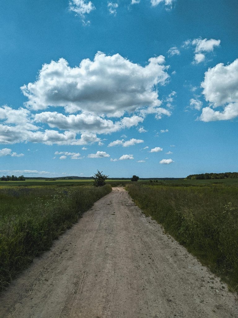 an-unpaved-country-road-or-footpath-extending-into-the-distance