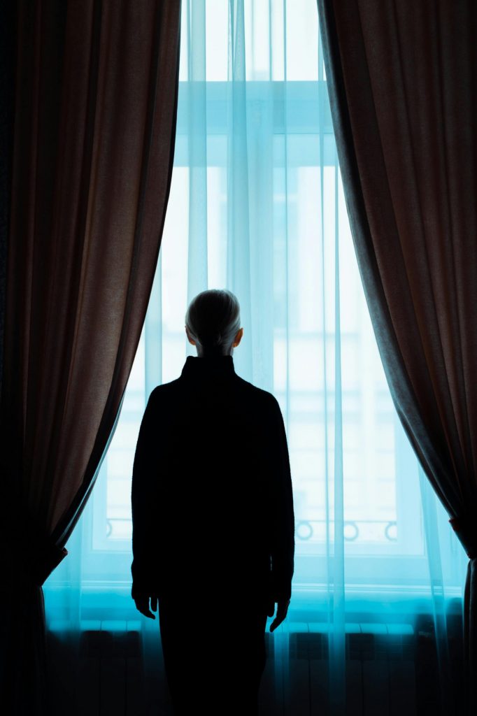 person-standing-alone-in-an-everyday-interior-space