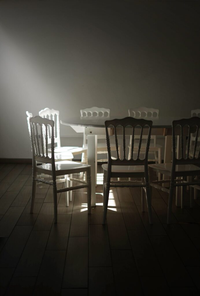 A-few-empty-chairs-in-a-quiet-room-after-a-gathering-has-ended