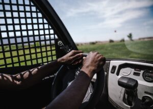 A pair of hands on a steering wheel