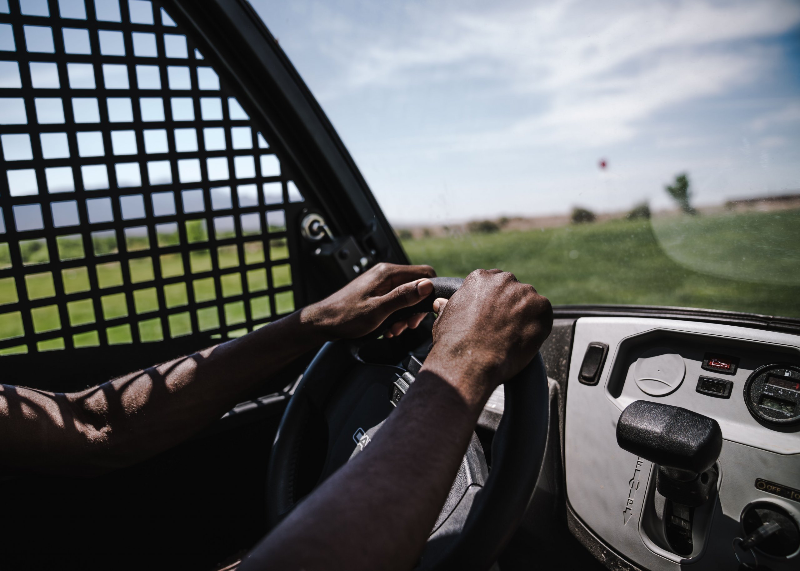 A pair of hands on a steering wheel