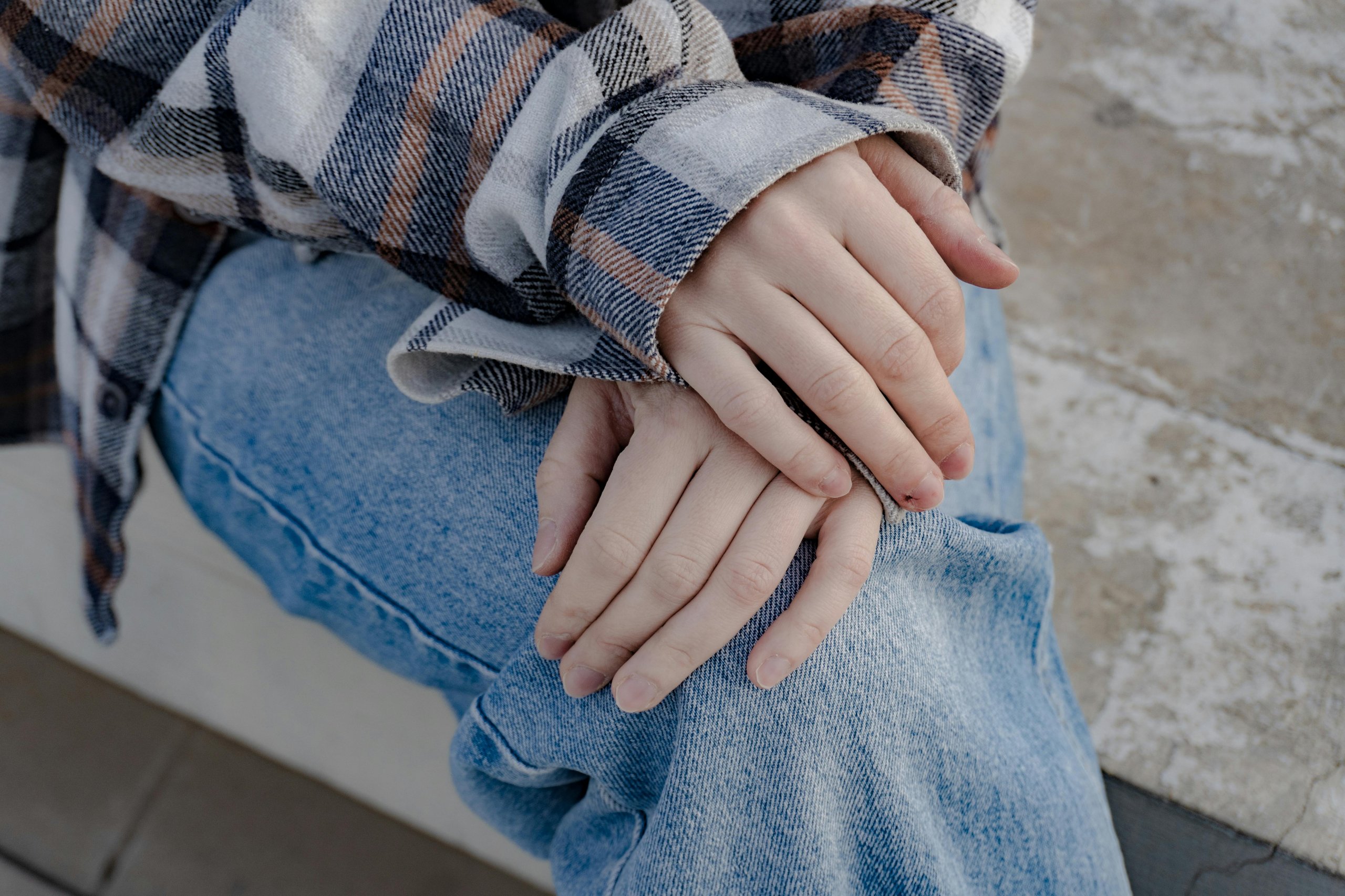 A-pair-of-hands-resting-still-and-open-on-a-lap-or-on-a-desk