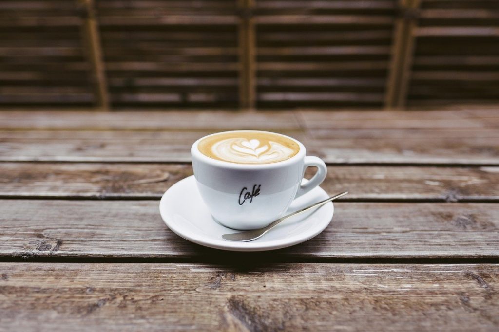 Morning-light-on-an-empty-wooden-table-with-a-single-cup-of-coffee