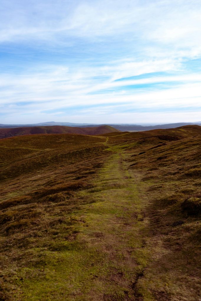 a-faint-footpath-worn-across-open-grass-or-moorland