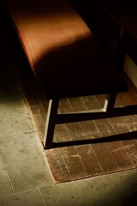 a-shaft-of-warm-light-across-the-floor-of-a-dim-room