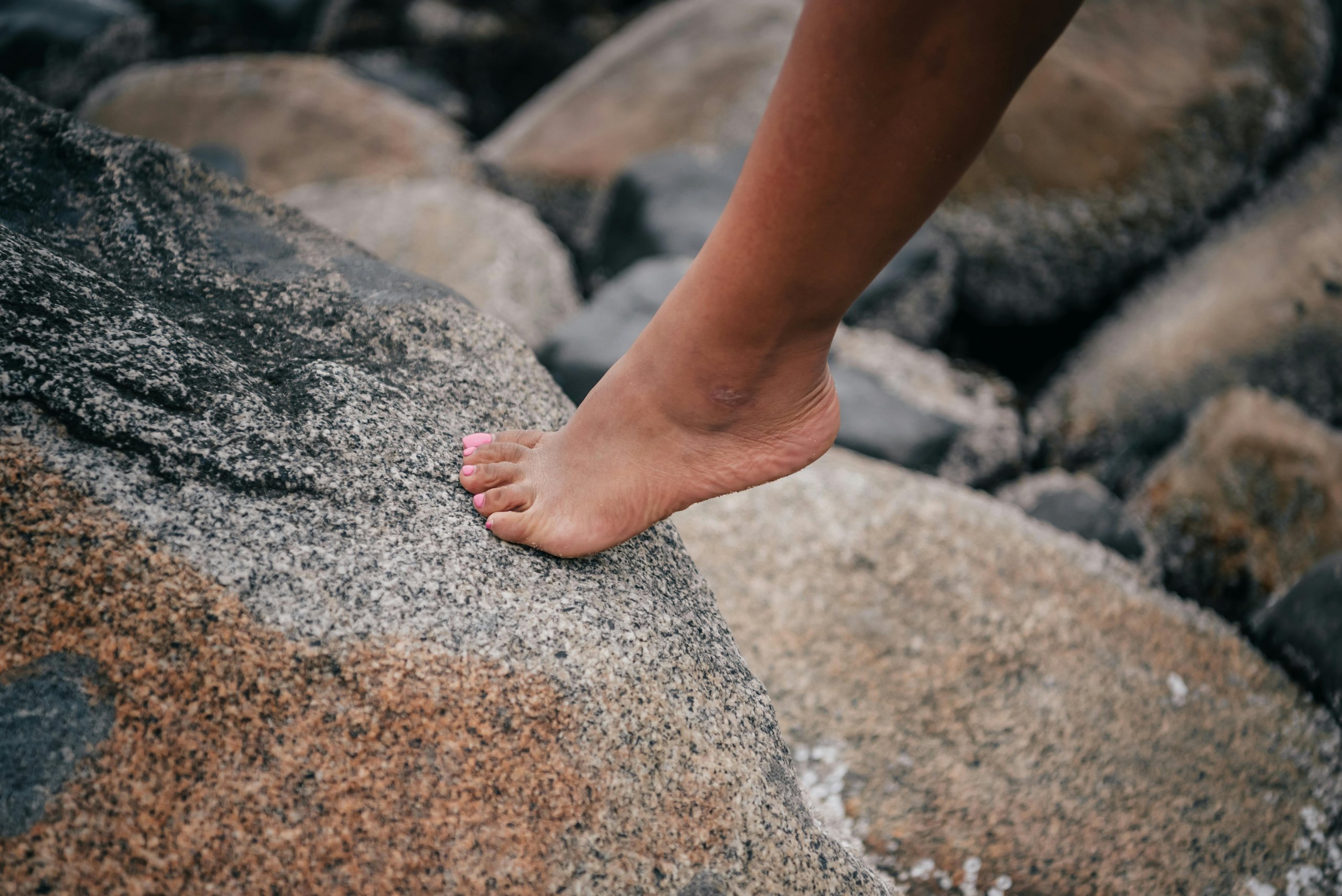 a-single-foot-mid-step-about-to-meet-soft-uncertain-ground