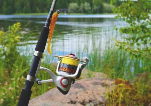 A-quiet-riverbank-with-a-simple-fishing-rod