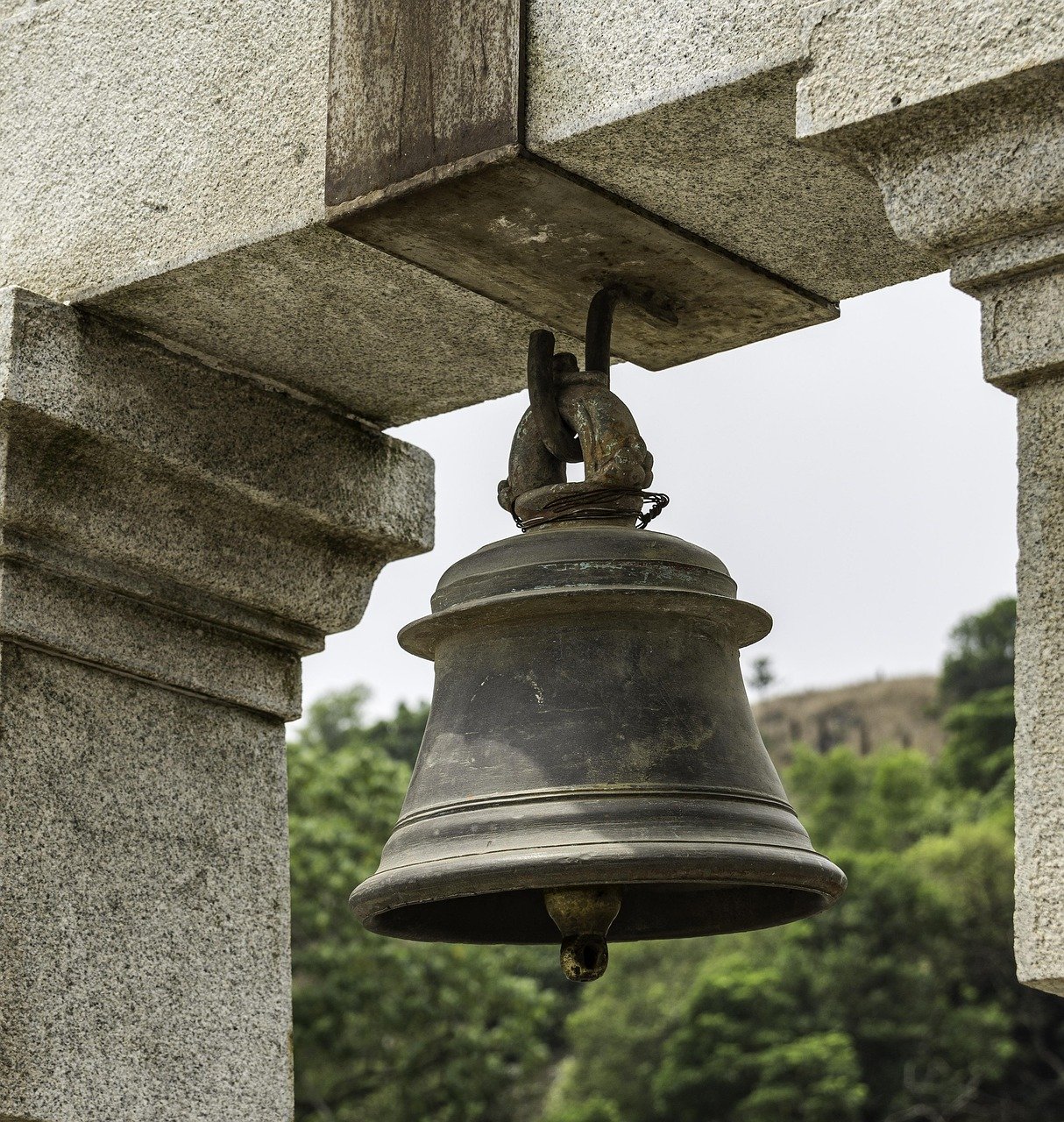 old-bronze-bell-hanging-still-in-soft-light