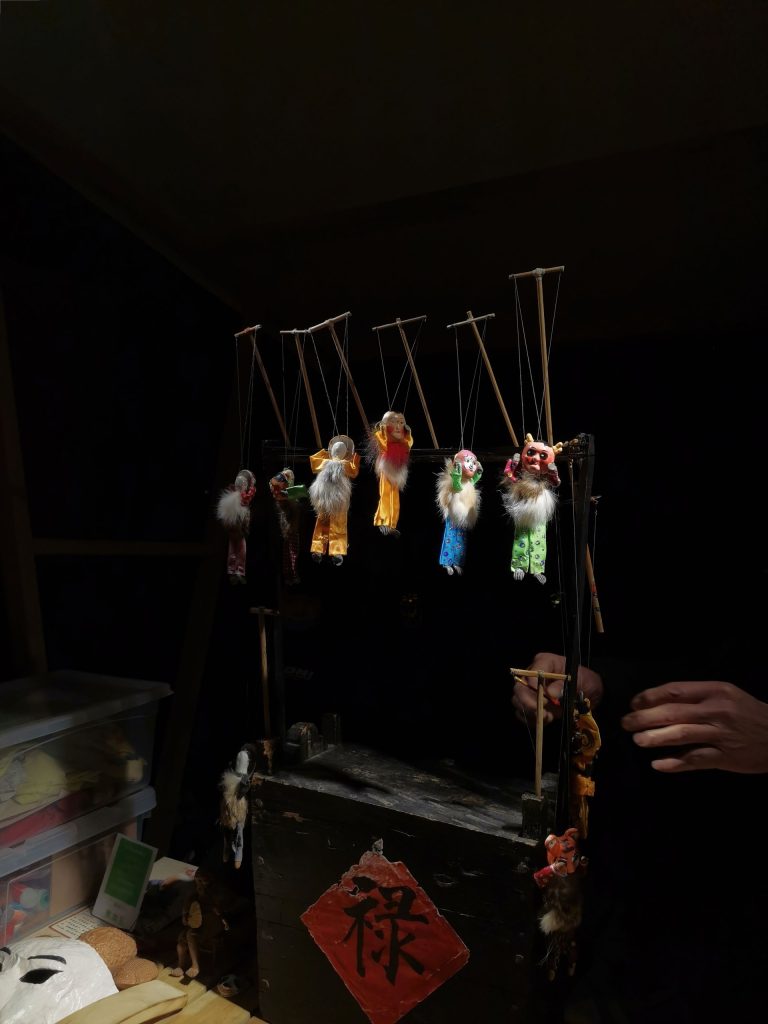A-dozen-marionette-strings-descending-toward-one-small-wooden-figure