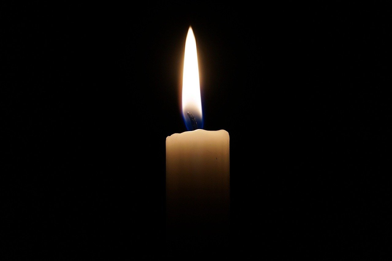 A-single-lit-candle-whose-light-fills-the-entire-dark-room