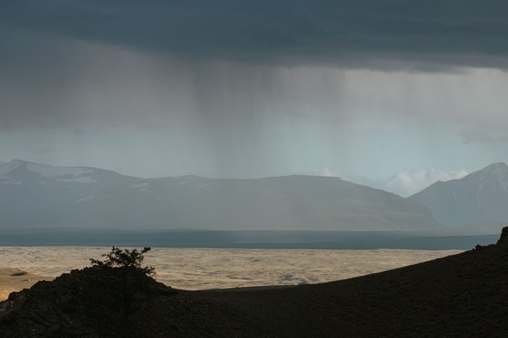 Rain-falling-over-one-half-of-a-wide-valley
