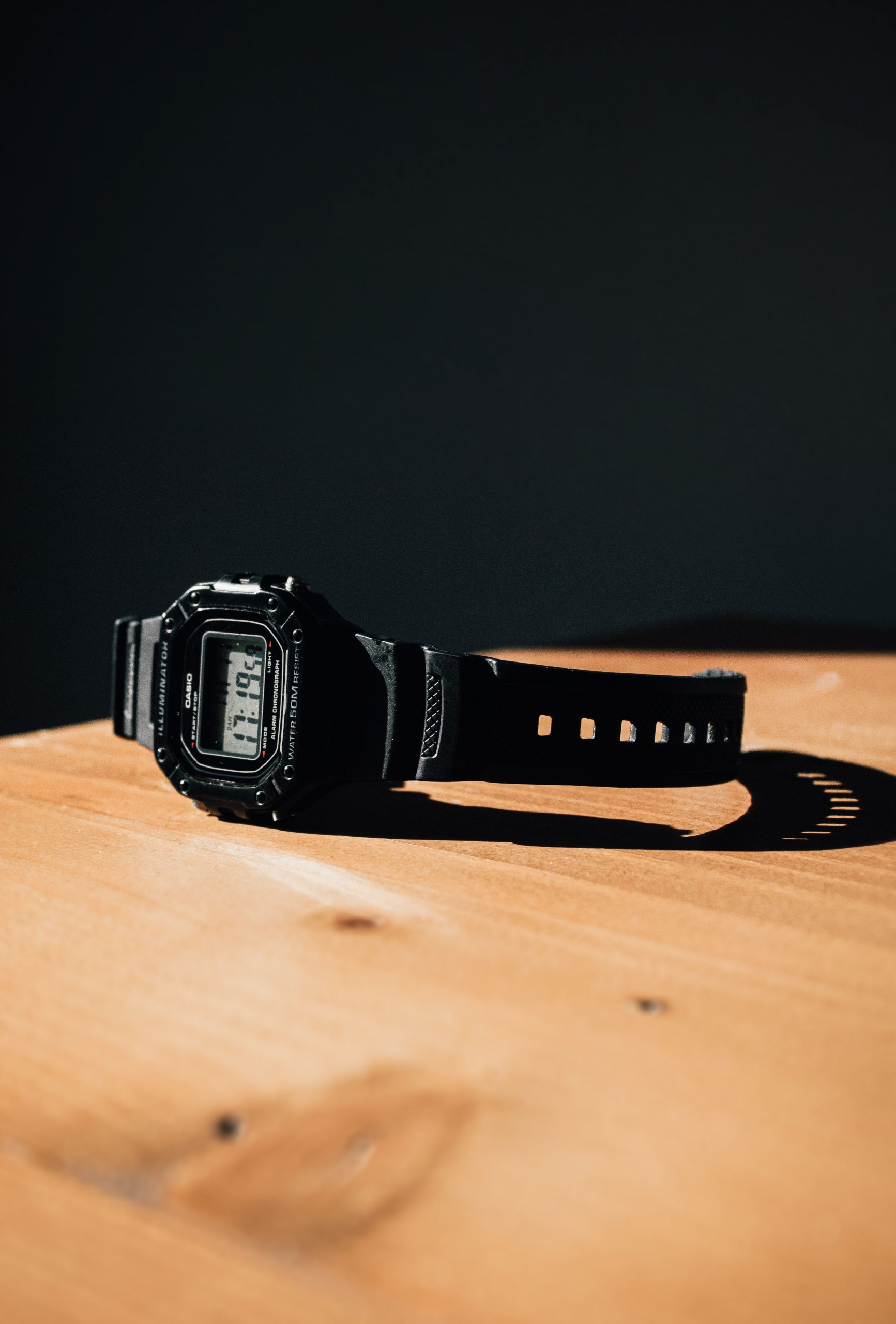 wristwatch-lying-face-down-on-a-wooden-table